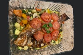 Fried tilapia fish makes to perfection on the top of Mixed vegetables a la bassamoise. comes with attieke or rice. 